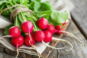 A bunch of radishes on a wooden table photo