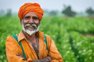 A Happy Indian Farmer Standing Proudly in His Lush Green Field of Crops photo