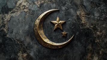 Crescent moon and star symbol on a dark marble gravestone. photo