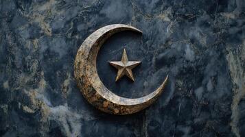 Islamic crescent moon and star design on a dark marble grave. photo