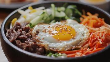 Bibimbap with Fried Egg, Meat, and a Mix of Vegetables photo
