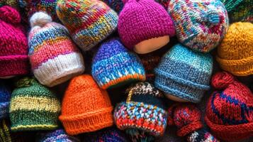 A variety of colorful and unique hand knitted bean bags on display. photo