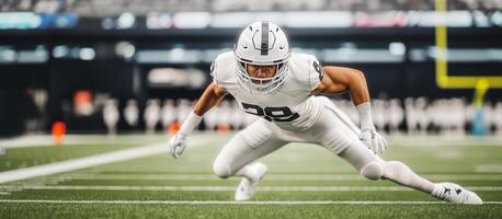 An American football player in a white uniform prepares to make an interception of another player during a match photo