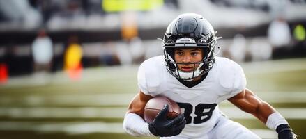 American football player in black helmet and white uniform makes a speed maneuver with ball in hand photo