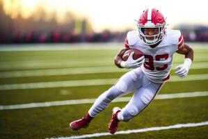 American football player in a red helmet and white uniform makes a speed maneuver with the ball in his hand during a match photo