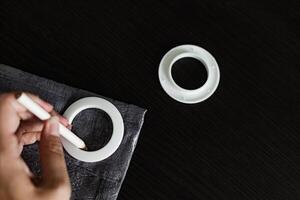 installing eyelets in curtain, marking for grommet installation photo