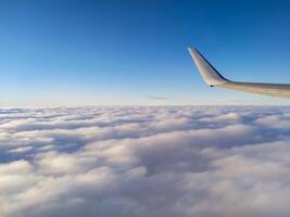 airplane tail in the clouds high in the sky photo