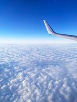 airplane tail in the clouds high in the sky photo