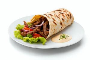 Shawarma with sliced meat, fresh vegetables, and garlic sauce on a white plate against a clean white backdrop photo