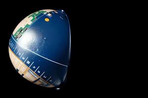 A sleek, modern technology symbol featuring a circuit board, digital globe, and interconnected lines in a minimalist, monochromatic design, embodying modern technology and connectivity photo