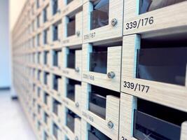 Close-up of a row of wooden mailboxes or lockers, showcasing modern design and organizational structure. Perfect for illustrating themes of security, organization, and residential or office environmen photo