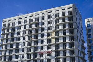 SHYMKENT, KAZAKHSAN - JANUARY 03, 2024. residential building under construction with installed thermal insulation panels on facade photo