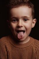Portrait of joy happy white Caucasian preschooler child boy kid with tongue hanging out photo