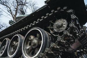metal old caterpillar track of military army metal Soviet tank in close up photo