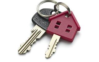 Two keys with a house-shaped key fob on a silver ring isolated on white. photo