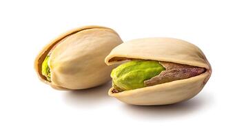 Two pistachios, one open to reveal the green nut inside, on a white background. photo