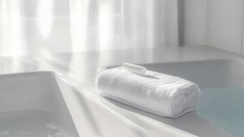 White Towel and Cream on Bathtub Edge Against Pristine Background photo