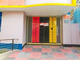 Modern Colorful Gate Design with Red and Yellow Panels in Front of a Building Entrance photo