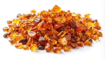 Crushed amber resembling golden gemstone particles beautifully scattered and photographed from a wide angle perspective isolated on a clean white background, white background photo