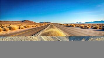 A tumbleweed rolling over an empty desert road under a clear sky High Angle, tumbleweed, high angle, clear sky, empty photo