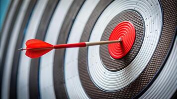 A close up of a target board with a red arrow slightly missing the center creating a forced perspective effect, business., bullseye, strategy, missing the target, determination, close-up photo