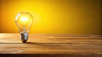 innovation, nature, electricity,glowing, idea, environment, power, wooden table, sustainable, Glowing light bulb illuminating a wooden table against a yellow background at eye level photo