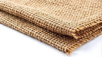 Burlap fabric commonly known as jute is depicted in this stock photo on a white isolated background from a low angle, Burlap, backdrop, background, low angle, reusable, rough, textile