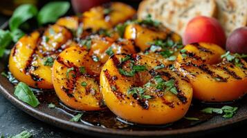 Grilled peaches with herbs, served on a plate for a delicious dish. photo