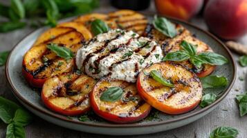 Grilled peaches with goat cheese and basil photo