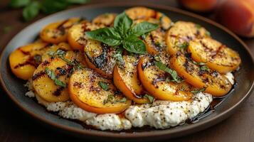 Grilled peaches on creamy cheese with herbs for a delicious dish. photo