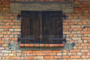 brick wall with a window in the middle photo