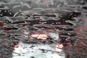 Soapy water blowing up window from automatic car wash. photo