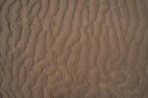 Sand pattern after high tide in the beach photo