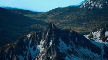 A view of a mountain range with snow on it video