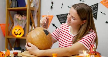 Woman Painting a Pumpkin for Halloween video
