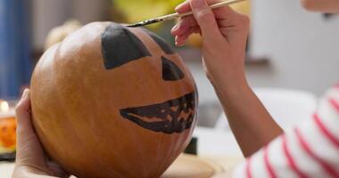 Painting a Jack-o'-lantern Face on Pumpkin video