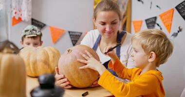 Child Decorating Pumpkin with Mother for Halloween video