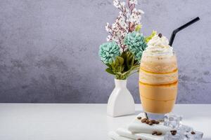 Fresh glass of Coffee Frappe with Whipped Cream and Floral Decor photo