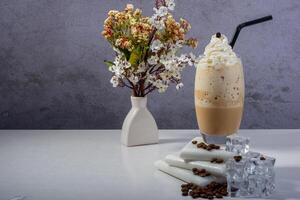 A fresh creamy iced coffee frappe topped with whipped cream photo
