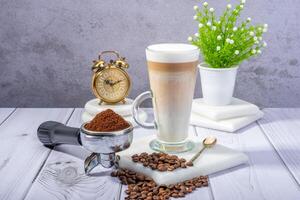 coffee beans, ground coffee, and a steaming mug of freshly brewed coffee photo