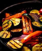 Grilled vegetables on black background with copy space photo