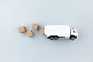 White toy truck with boxes on a light background, space for text. photo