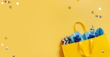 Yellow package with Christmas gifts. Festive flatlay with place for text photo