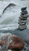Huge streams of water flowing downstream. Creative. Close-up shooting with cold waters that beat against the rocks of the bottom. video