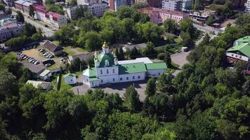 Aerial view of the ancient cave monastery with cityscape. Clip. Orthodox Monastery, memorial complex of monasteries surrounded by trees. video