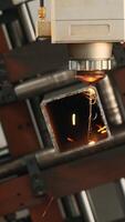 Industrial Laser cutting the edge of a square shaped pipe. Creative. Automated Industrial machine, close up view. video