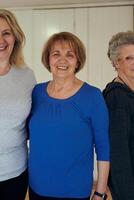 A vibrant community of senior women, guided by their instructor, embraces the enriching journey of yoga, fostering unity, well-being, and a shared commitment to active aging photo