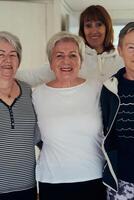 A vibrant community of senior women, guided by their instructor, embraces the enriching journey of yoga, fostering unity, well-being, and a shared commitment to active aging photo