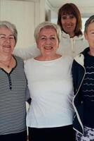 A vibrant community of senior women, guided by their instructor, embraces the enriching journey of yoga, fostering unity, well-being, and a shared commitment to active aging photo