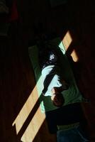 Senior woman practicing stretching and meditation on the floor, focusing on proper alignment and relaxation. photo